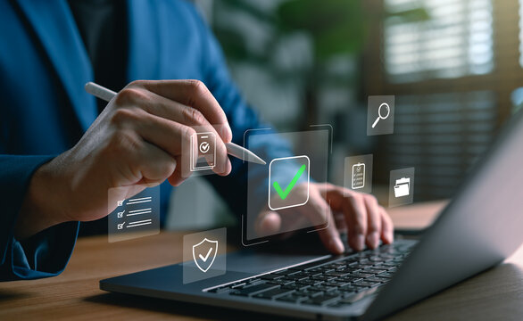 Businessman using digital pen and laptop with online document approval system, task checklist management, and secure data verification concept for digital workflow and business automation.