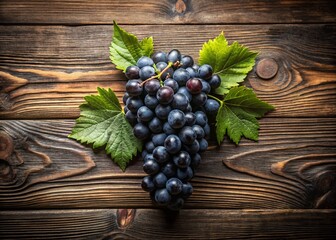 Fototapeta premium Overhead View of Black Grapes and Leaves on Rustic Wood