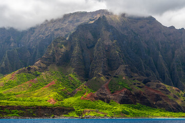 The rugged, lush cliffs of Hawaii’s Na Pali Coast rise above the Pacific.