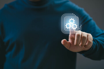 A person interacts with digital gears representing automation and technology. The image symbolizes...