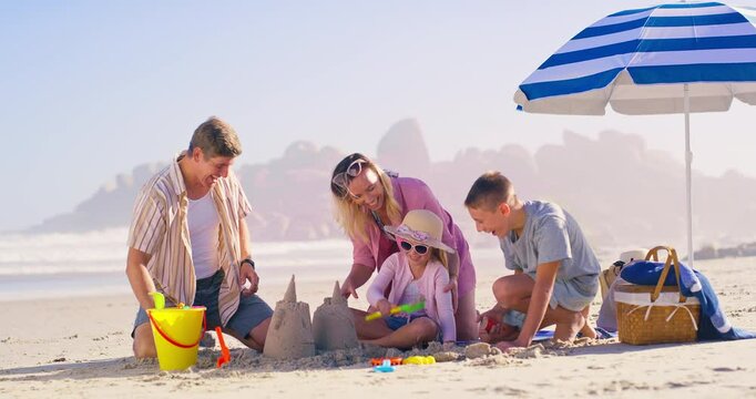Family, sea and building a sandcastle on holiday, love and laughing together for humor in nature. Parents, children and playing games with sand on vacation, outdoor and funny conversation with toys