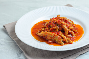 Dakbal. or Korean spicy chicken feet. Served on white plate.