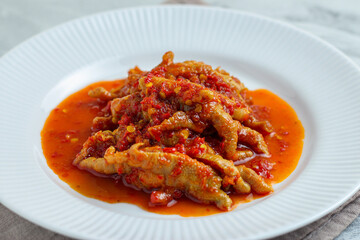 Dakbal. or Korean spicy chicken feet. Served on white plate.