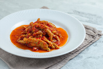 Dakbal. or Korean spicy chicken feet. Served on white plate.