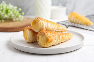 Kue cumcum. Horn pastry or cone pastry with vanilla cream.