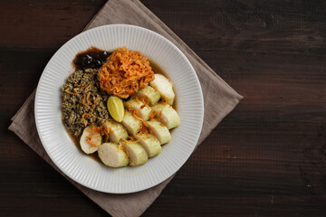 Lontong kupang, or rice cake with small white clams. traditional food of east java, indonesia.