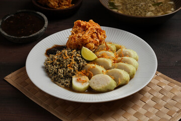 Lontong kupang, or rice cake with small white clams. traditional food of east java, indonesia.