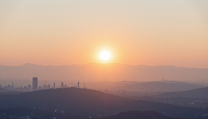 Breathtaking sunrise over city skyline, with soft hues of orange and pink illuminating horizon. silhouette of mountains adds depth to serene landscape, creating peaceful atmosphere