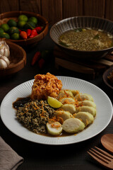 Lontong kupang, or rice cake with small white clams. traditional food of east java, indonesia.