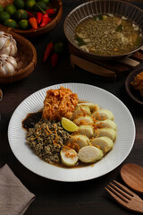 Lontong kupang, or rice cake with small white clams. traditional food of east java, indonesia.