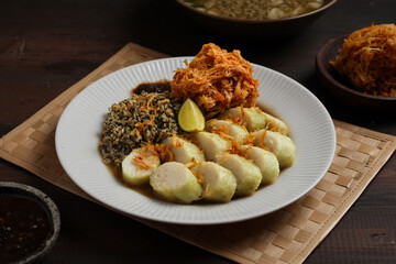 Lontong kupang, or rice cake with small white clams. traditional food of east java, indonesia.