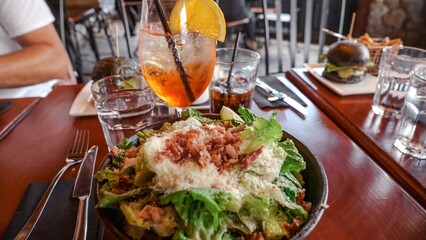 Fresh salad with grilled chicken and vegetables on a wooden table