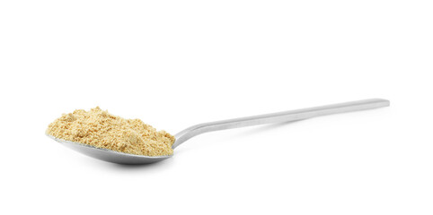 Superfood. Mustard powder in spoon isolated on white