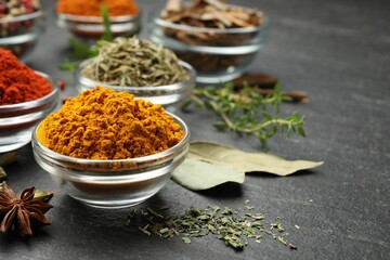Different aromatic spices on grey table, closeup