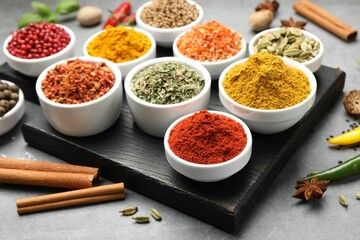 Different aromatic spices on grey table, closeup