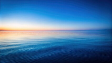 Serene ocean scene at dawn, showcasing a tranquil expanse of water under a pastel sky