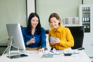 Two businesswoman and man discuss investment project working and planning strategy with tablet