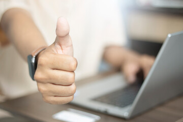 Thumbs up hand with laptop, customer satisfaction, business approval, success concept, remote work, digital life