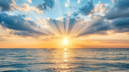 Breathtaking sunset over ocean with rays of light illuminating water surface