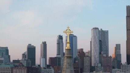 Aerial view of a crucifix on top of a church steeple in New York City