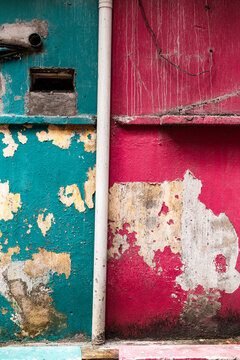 Textured colorful decaying walls with drain pipe Little India Kuala Lumpur