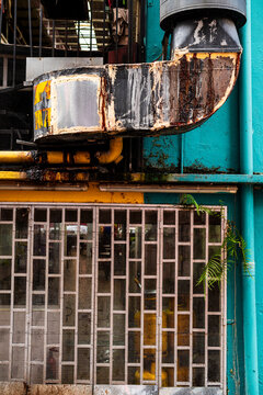 Rusty ventilation pipe and vibrant blue background