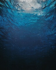 Calming view of a blue ocean with gentle water flowing peacefully under a clear sky above