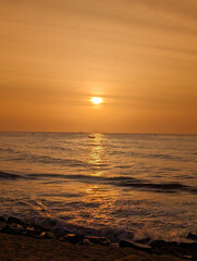 At dawn, gentle sea waves kiss the shores of Pondicherry Beach, with sunlight glistening across the water — ideal for serene coastal travel moments.