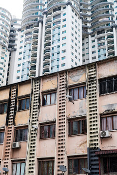 Peeling facade under modern towers, Kuala Lumpur, Malaysia