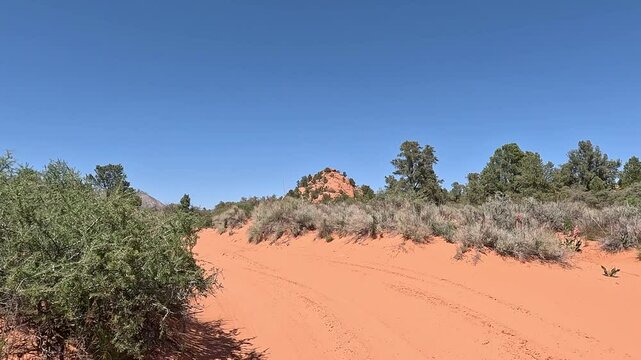Driving red sandy desert trail Utah POV. Southern Utah off road recreation nature and exploring. Desert mountain canyon river valley trail ride adventure area. Remote wilderness.