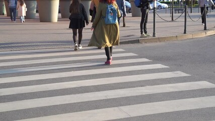 Slow motion dynamic video of people crossing crosswalk for pedestrians close up in busy city day - Powered by Adobe