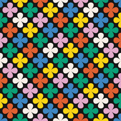 Colorful floral pattern with clover shapes and petals on black background. Seamless geometric vector design in retro style. High quality illustration for decor and textile