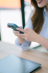 Businesswoman working in office while talking on the phone and taking notes