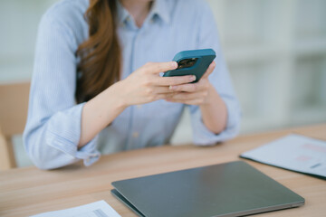 Businesswoman working in office while talking on the phone and taking notes