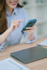 Businesswoman working in office while talking on the phone and taking notes