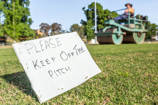 A ground level view of a handwritten side on the side of a cricket pitch