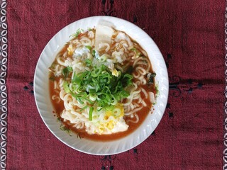 Instant noodles cooked with eggs and sprinkled with spring onions