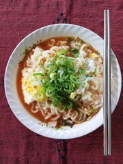 Instant noodles cooked with eggs and sprinkled with spring onions