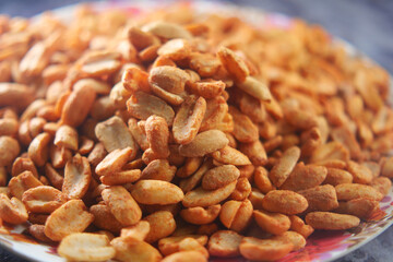 Roasted peanuts served on a colorful plate at a local market