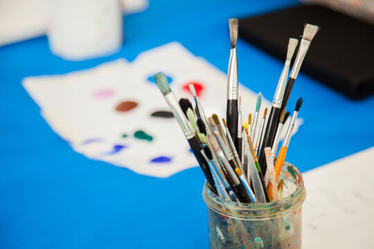 Coloured paint and painting brushes for children's art class