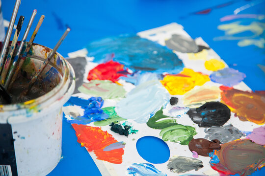Coloured paint and painting brushes for children's art class