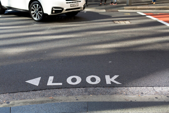 Look sign on a road at a busy intersection in the Sydney CBD