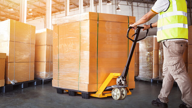 Workers Loading Bulk of Package Boxes in Warehouse. Forklift Pallet Jack Loader. Distribution Storage Warehouse. Supply Chain, Shipping Supplies Warehouse Logistics.		
