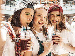 Three young beautiful smiling hipster female in trendy summer clothes. Sexy carefree women in...