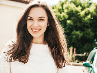 Closeup portrait of beautiful smiling brunette model. Trendy female posing in the street...