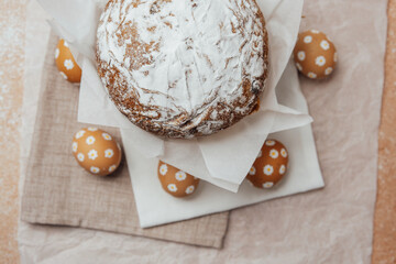 Traditional Easter cake with hand-painted daisy eggs on fabric. Homemade festive baked goods and...