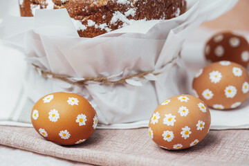 Traditional Easter cake with hand-painted daisy eggs on fabric. Homemade festive baked goods and...