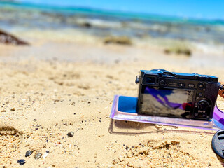 A camera placed on the beach, capturing the peaceful coastal scenery under natural light.
