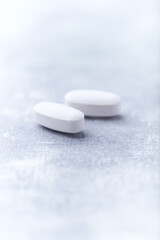Amino acids tablets on wooden background. Soft focus. Close up	