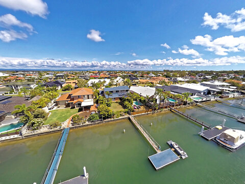 Aerial drone uav footage over waterfront properties with private jetties and solar panels in Newport
